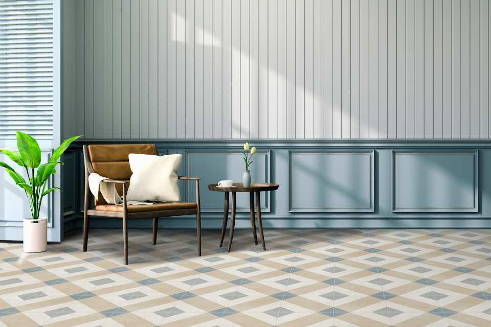 bold coloured geometric tiles in entry space with leather chair and blue accents